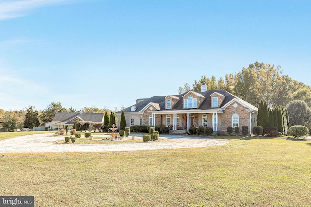 cape cod house with a front lawn