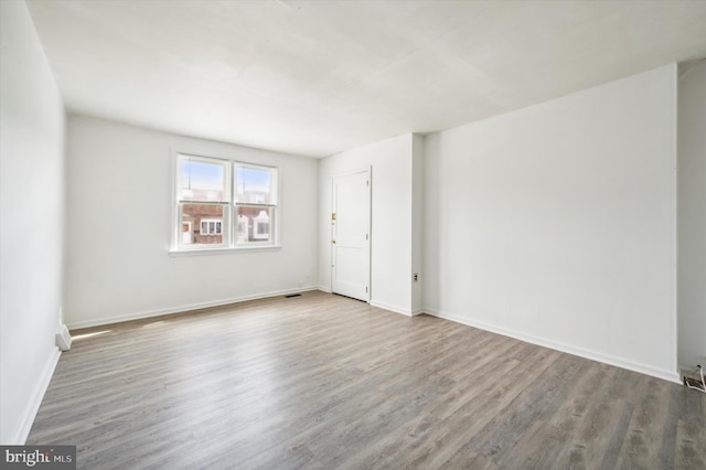 spare room with hardwood / wood-style flooring