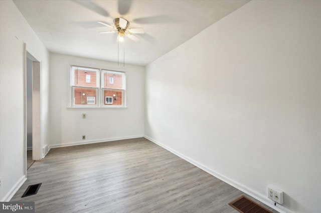 spare room with light wood-type flooring and ceiling fan