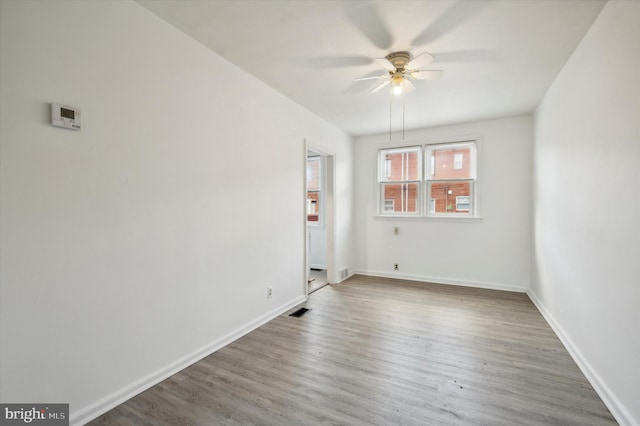 unfurnished room with ceiling fan and dark hardwood / wood-style floors