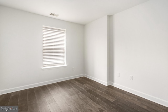 unfurnished room with a healthy amount of sunlight and dark hardwood / wood-style floors