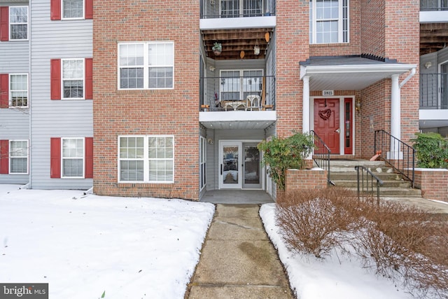 view of snow covered property entrance