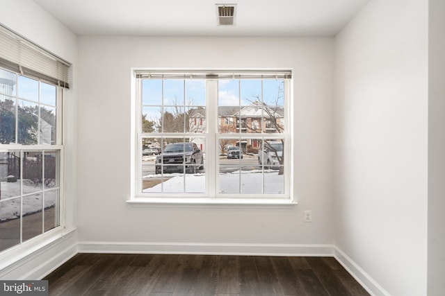 unfurnished dining area with dark hardwood / wood-style floors and a wealth of natural light