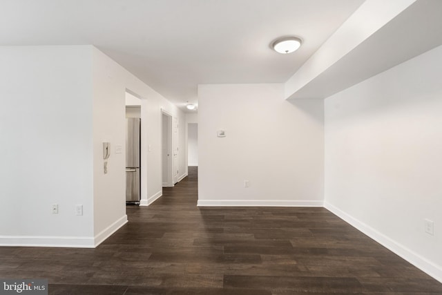 spare room with dark wood-type flooring