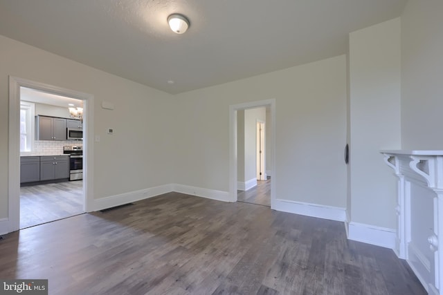 438 Green Spring Rd, York, PA 17403 - spare room with dark wood-style flooring, a notable chandelier, and baseboards