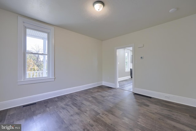 empty room featuring dark hardwood / wood-style flooring