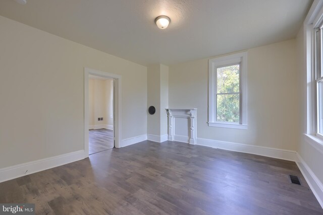 438 Green Spring Rd, York, PA 17403 - unfurnished living room with dark wood-style flooring, plenty of natural light, and visible vents