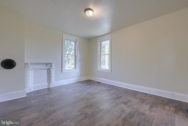 unfurnished living room with dark hardwood / wood-style floors