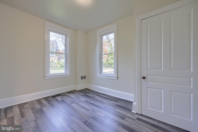 empty room featuring dark hardwood / wood-style flooring