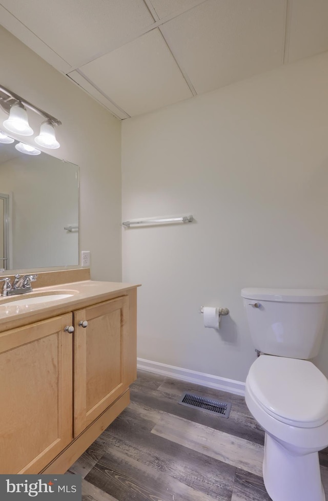 438 Green Spring Rd, York, PA 17403 - bathroom with toilet, wood finished floors, visible vents, baseboards, and vanity