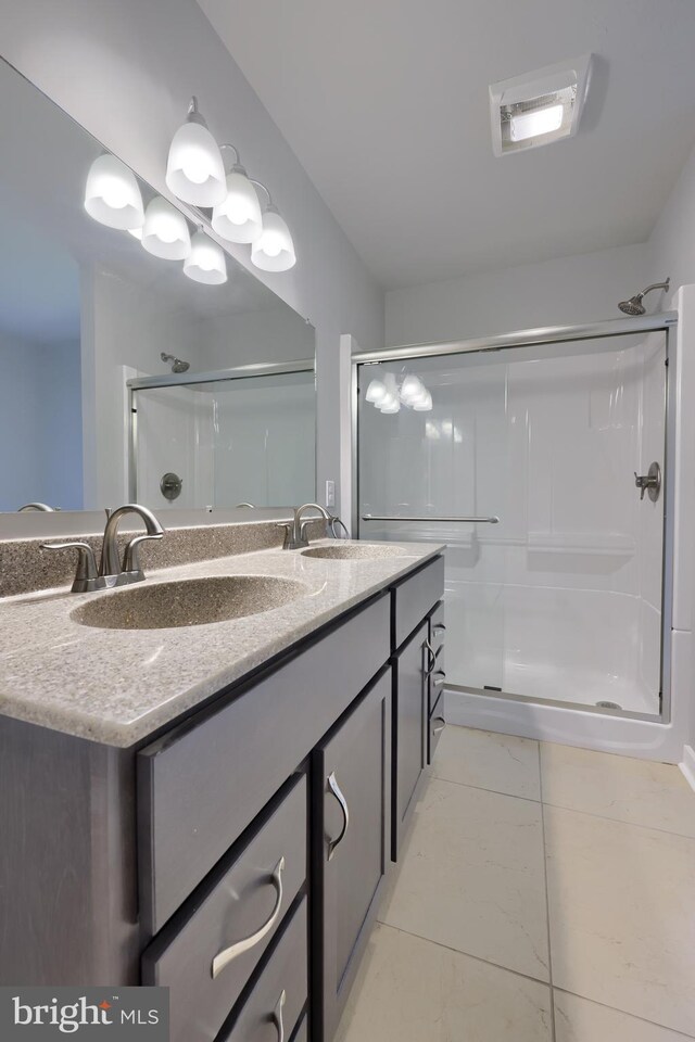 438 Green Spring Rd, York, PA 17403 - bathroom featuring a sink, double vanity, a shower stall, and marble finish floor