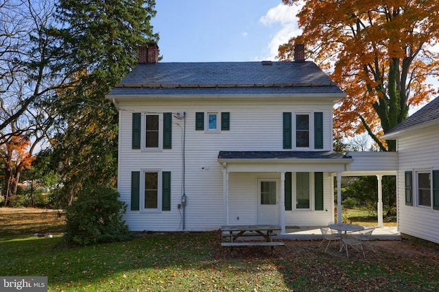 rear view of property with a patio area and a yard