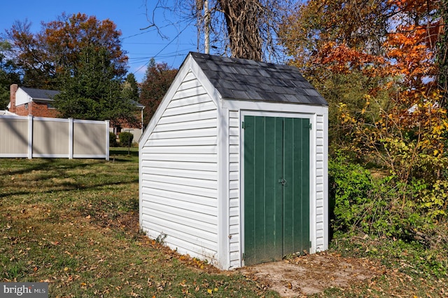 view of outdoor structure featuring a lawn