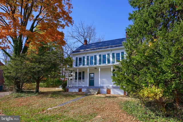 colonial inspired home featuring covered porch