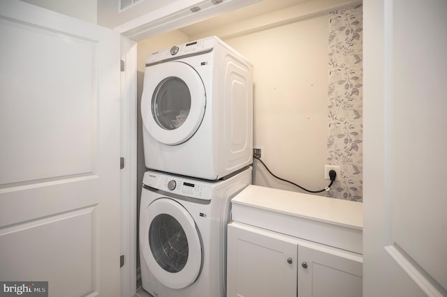 clothes washing area with stacked washer / drying machine