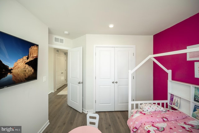 bedroom with a closet and dark hardwood / wood-style flooring