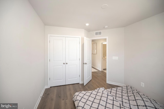 unfurnished bedroom featuring a closet and wood-type flooring