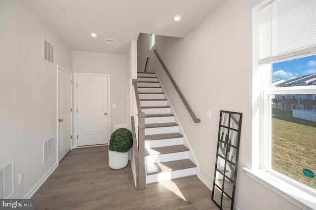 stairs featuring wood-type flooring