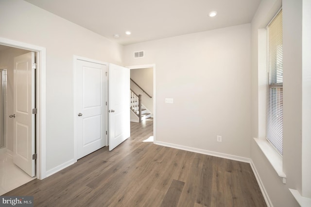 unfurnished bedroom with dark hardwood / wood-style floors