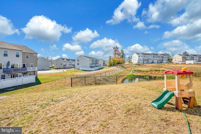 exterior space featuring a water view and a lawn