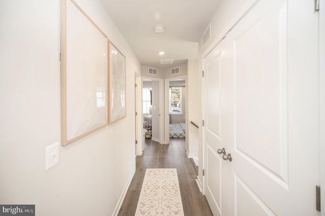 hall with dark hardwood / wood-style flooring