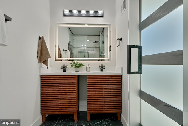 bathroom with vanity and a shower with shower door