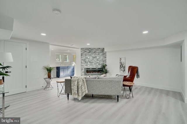 living room featuring light hardwood / wood-style floors and a fireplace