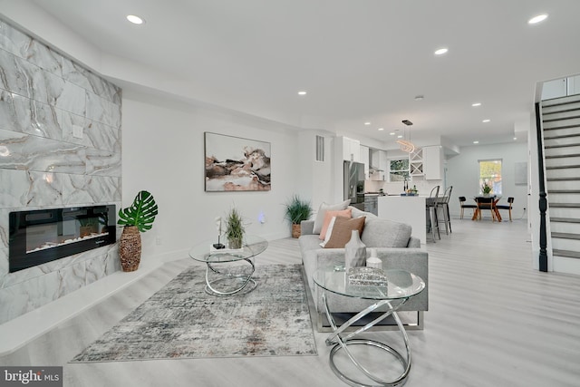 living room with a fireplace and light hardwood / wood-style floors