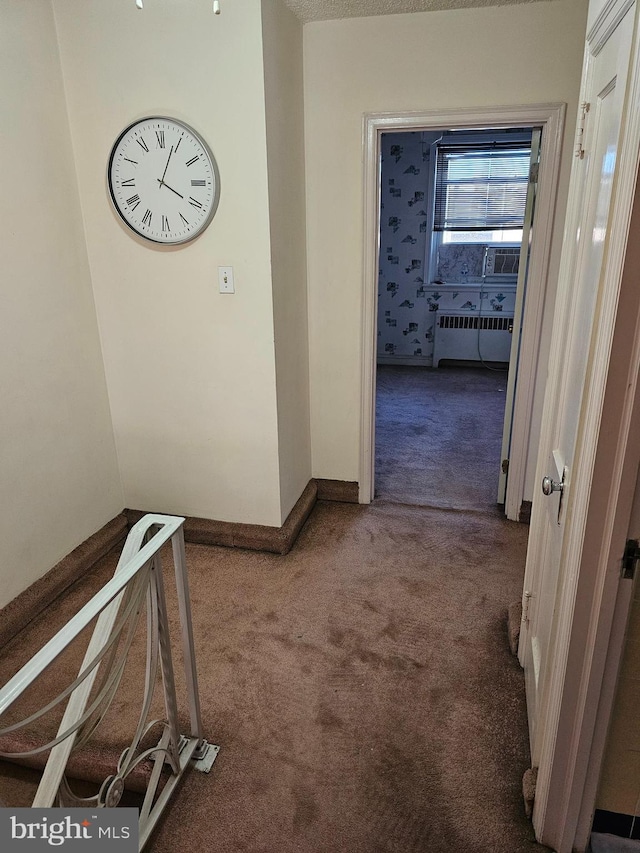 hall with carpet flooring and radiator heating unit