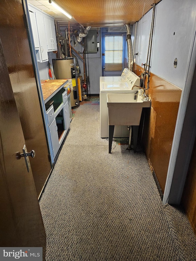 basement with water heater, carpet floors, electric panel, and separate washer and dryer