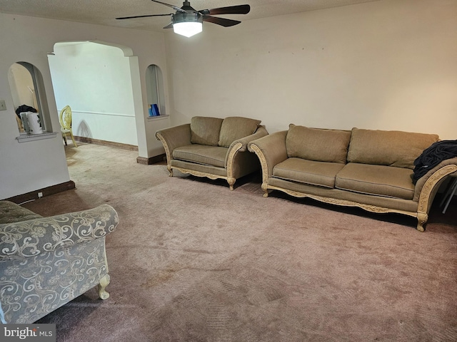 living room with carpet, a textured ceiling, and ceiling fan