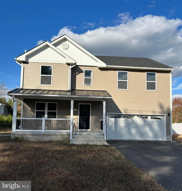 view of front facade featuring a garage and covered porch