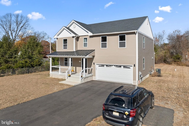 view of front facade with a garage and a porch