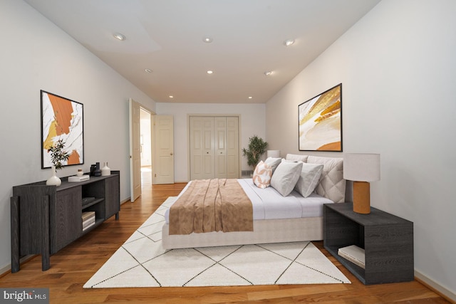 bedroom featuring hardwood / wood-style floors and a closet