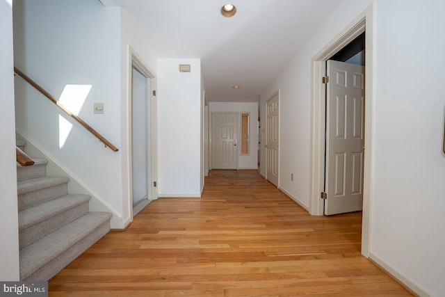 hall with light hardwood / wood-style flooring