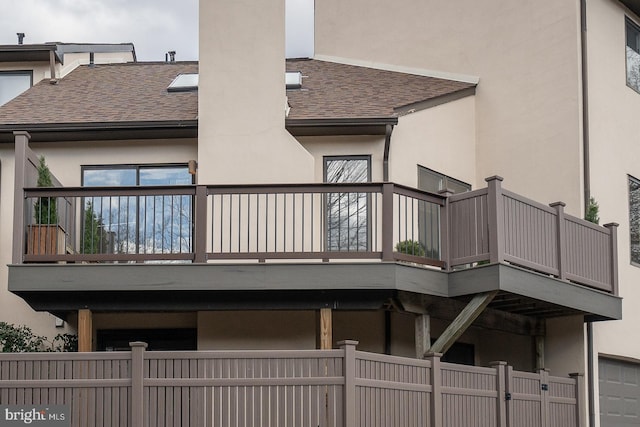 rear view of property with a balcony