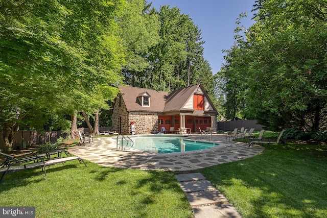 view of pool featuring a yard and a patio