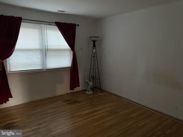 unfurnished room with hardwood / wood-style floors