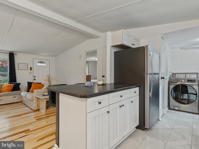 kitchen featuring lofted ceiling with beams, washer / clothes dryer, white cabinetry, and light hardwood / wood-style flooring