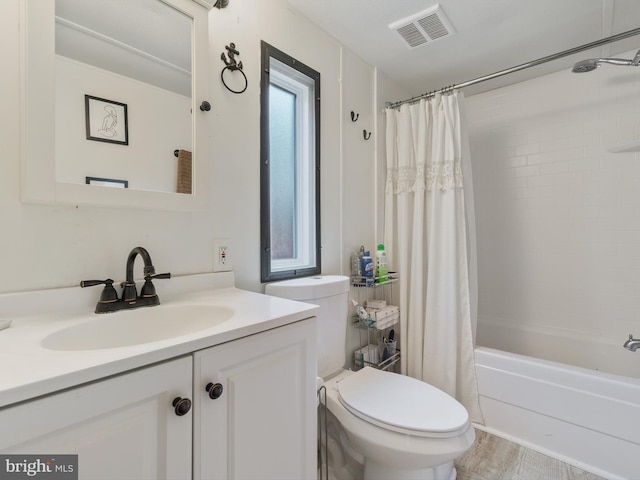 full bathroom with shower / bath combo, vanity, and toilet