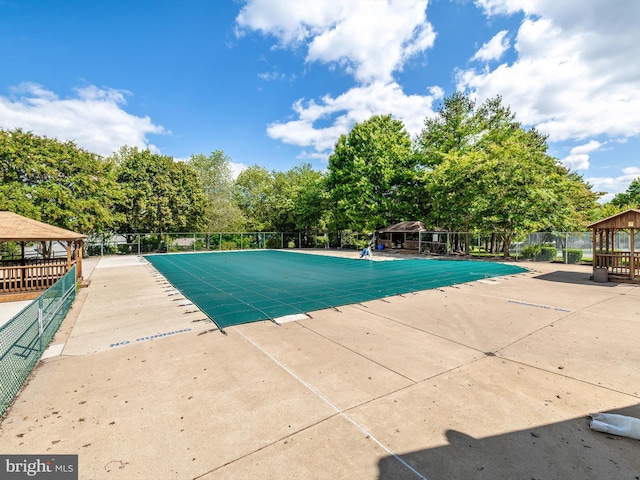 view of pool with a patio and a gazebo