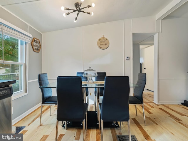 dining room with vaulted ceiling, hardwood / wood-style flooring, and a healthy amount of sunlight