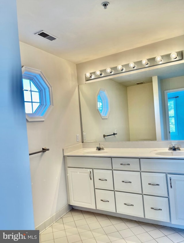 bathroom with tile patterned floors and vanity