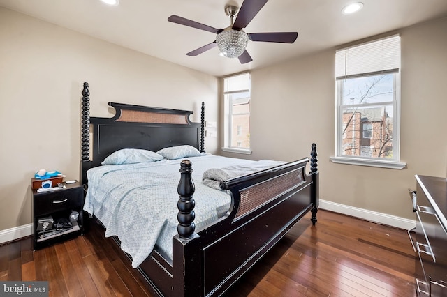 bedroom with ceiling fan and dark hardwood / wood-style floors