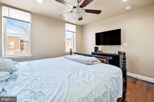 bedroom featuring dark hardwood / wood-style flooring and ceiling fan