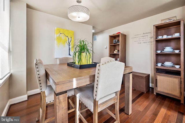 dining area with dark hardwood / wood-style floors