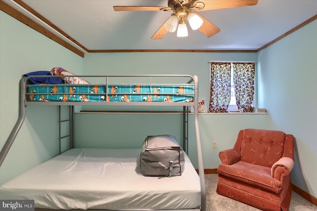 carpeted bedroom with ornamental molding and ceiling fan