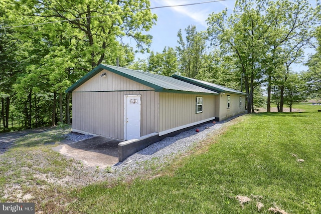 view of outbuilding featuring a lawn