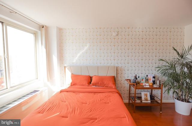 bedroom with wood finished floors and baseboards