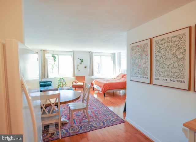 dining space featuring hardwood / wood-style floors and a healthy amount of sunlight